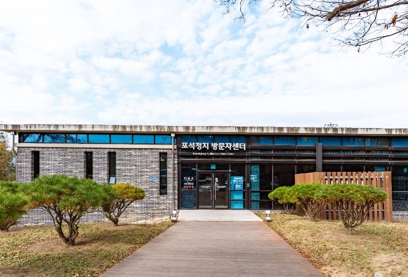 잔디와 소나무 앞에 자리한 포석정지 방문자센터 외관